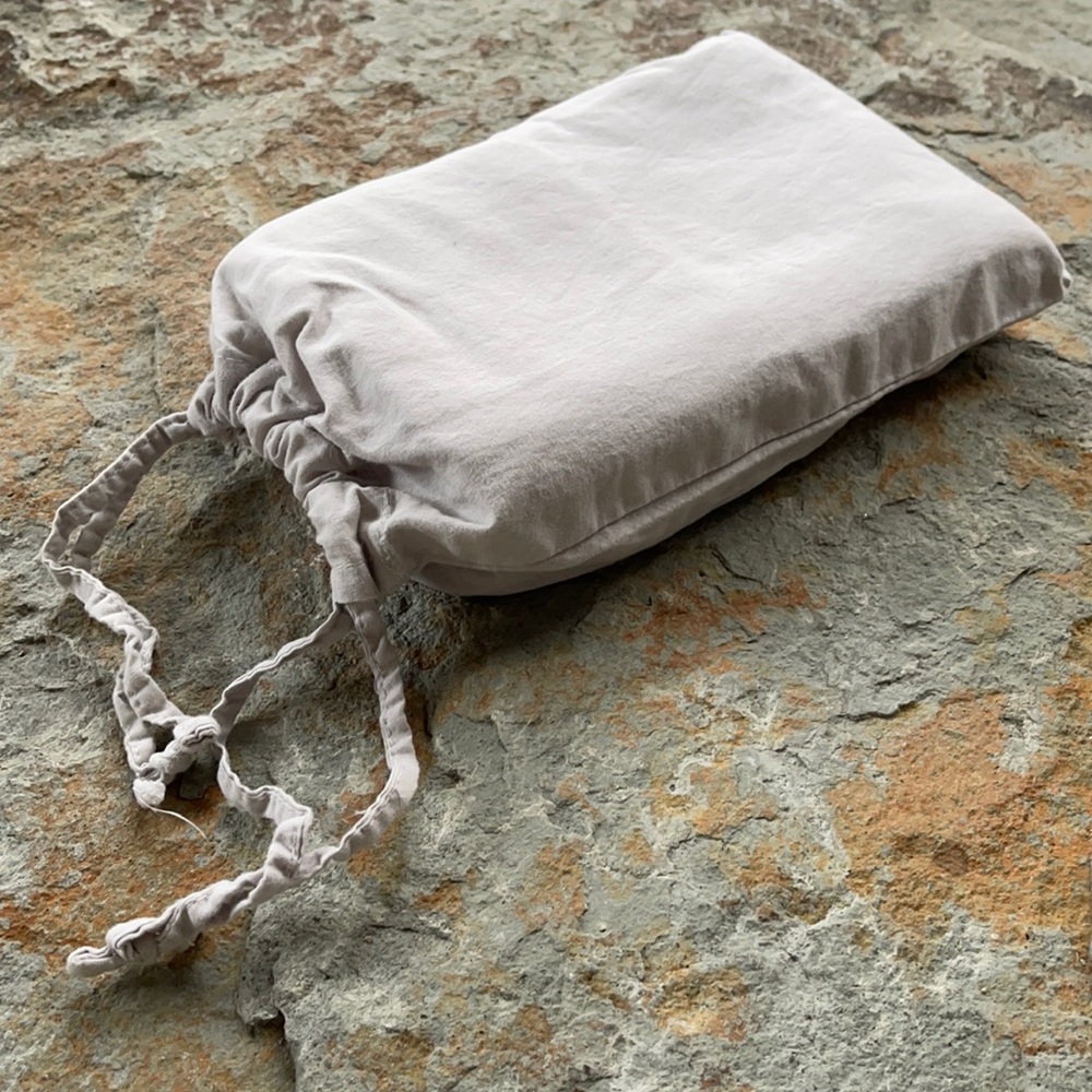 DKNY - pair- standard size pillow cases in soft grey. matching cloth bag.